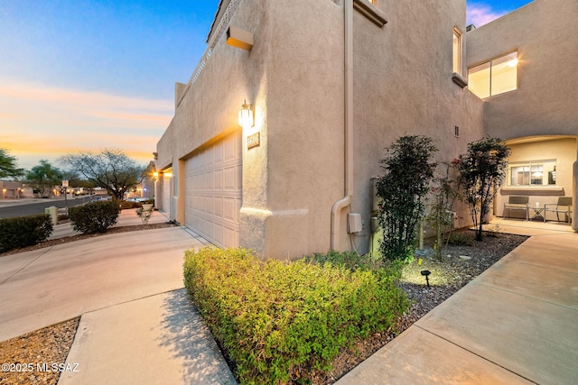 property exterior at dusk with a garage