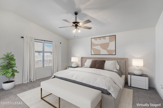 carpeted bedroom featuring lofted ceiling and ceiling fan