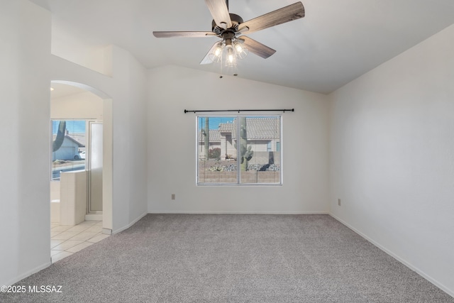 unfurnished room with ceiling fan, light colored carpet, and lofted ceiling