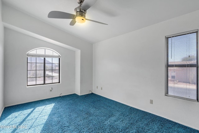 carpeted spare room with ceiling fan