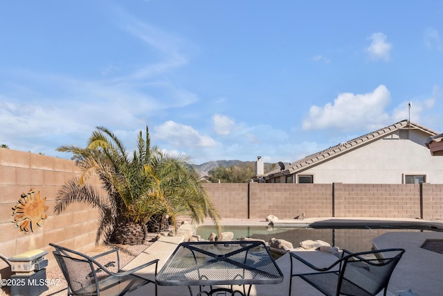 view of patio / terrace with a mountain view