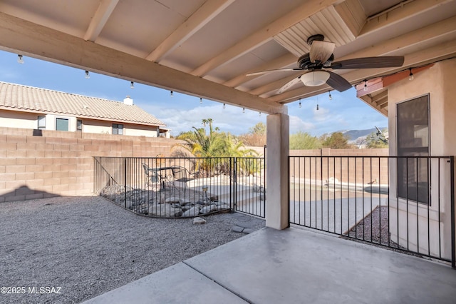 view of patio / terrace with ceiling fan and a mountain view