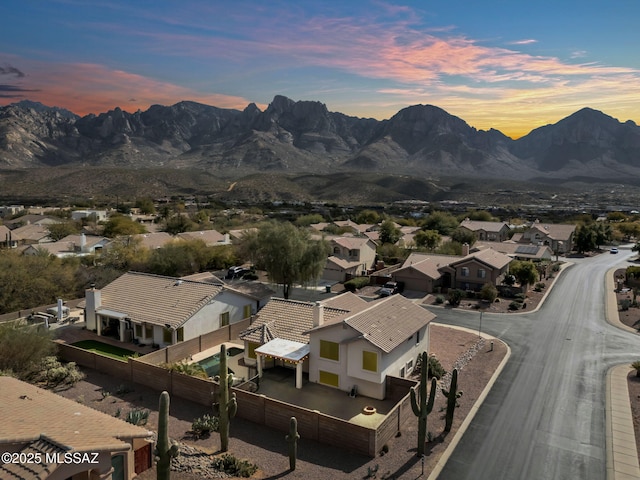 aerial view at dusk with a residential view and a mountain view