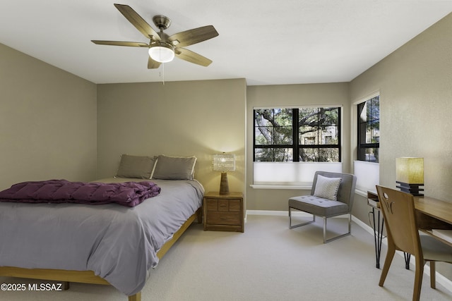 bedroom featuring ceiling fan and light carpet