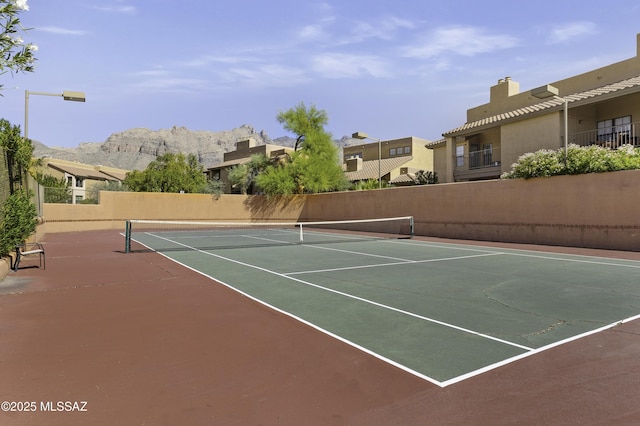 view of tennis court featuring a mountain view