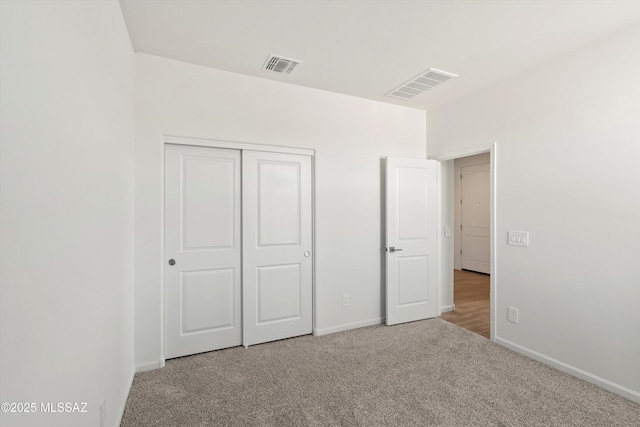 unfurnished bedroom with carpet and a closet