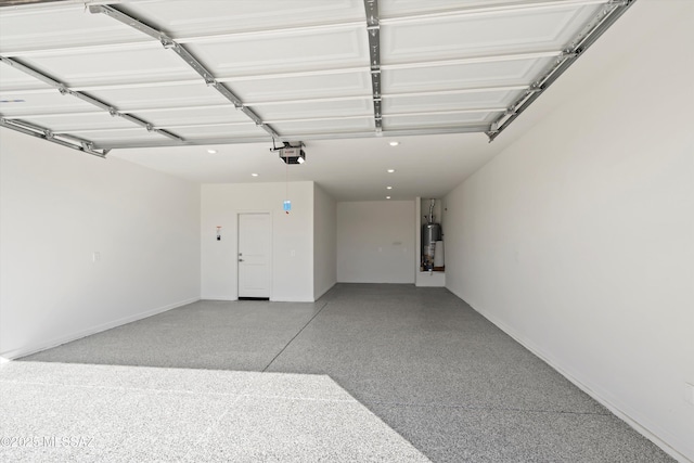 garage featuring gas water heater and a garage door opener