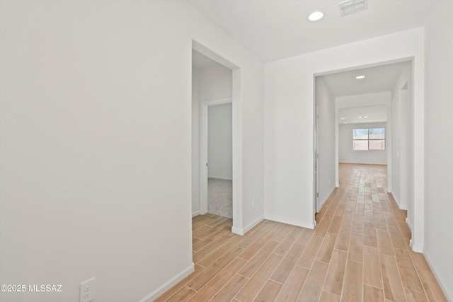 hall with light hardwood / wood-style floors