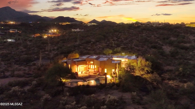 back house at dusk featuring a mountain view