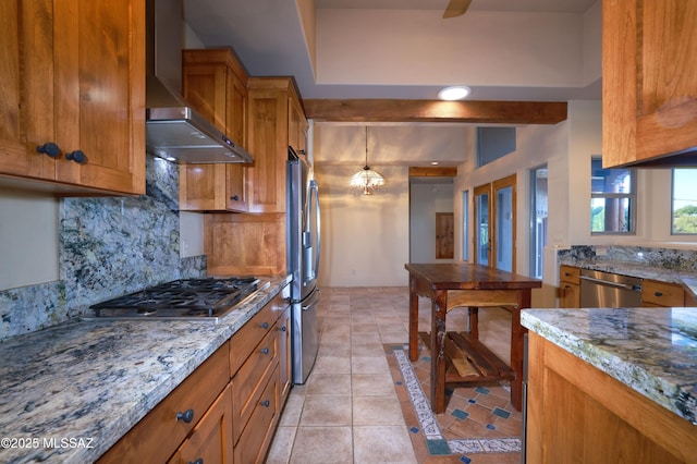 kitchen featuring light stone counters, wall chimney exhaust hood, light tile patterned floors, decorative backsplash, and appliances with stainless steel finishes