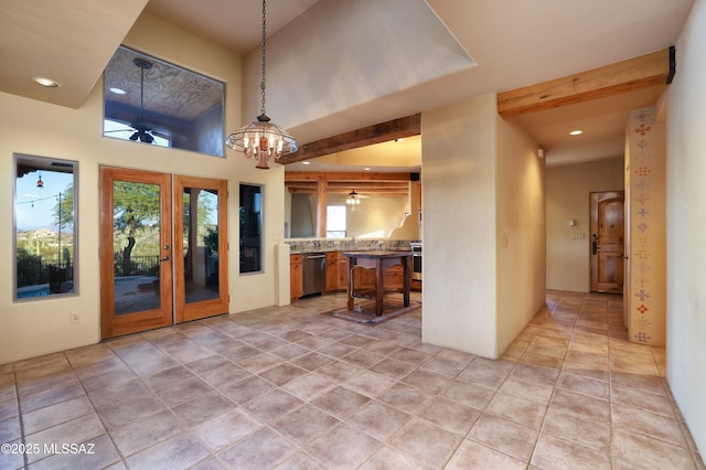 kitchen with french doors, a kitchen bar, stainless steel dishwasher, a chandelier, and beam ceiling