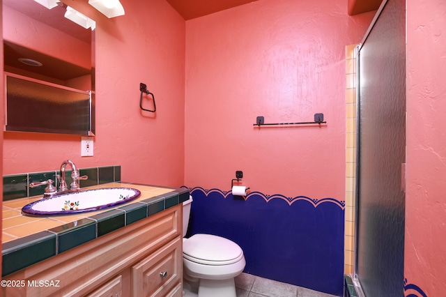 bathroom featuring toilet, tile patterned flooring, and vanity