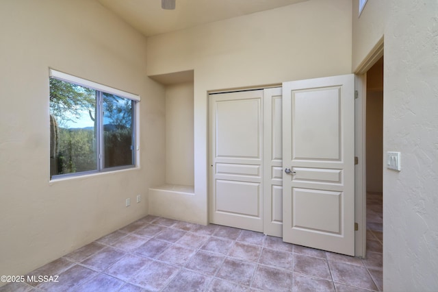 unfurnished bedroom with a closet and ceiling fan