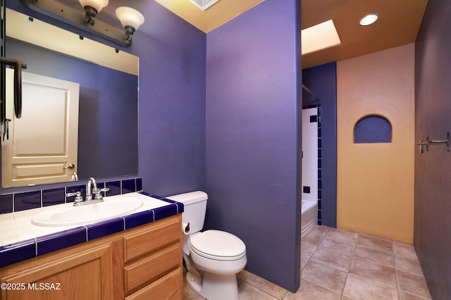 full bathroom with toilet, vanity, tile patterned floors, and bathtub / shower combination