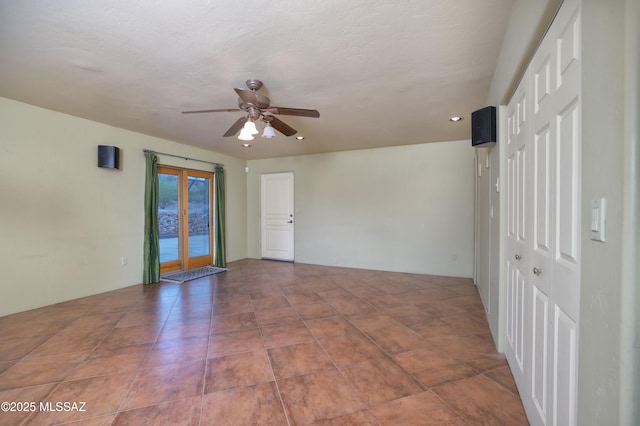 empty room featuring french doors and ceiling fan