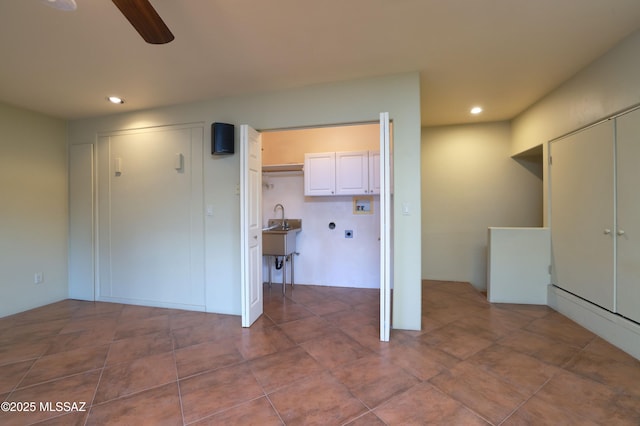 kitchen featuring white cabinets and ceiling fan