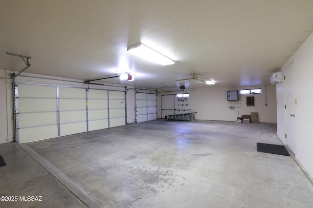 garage with electric panel, a wall unit AC, and ceiling fan