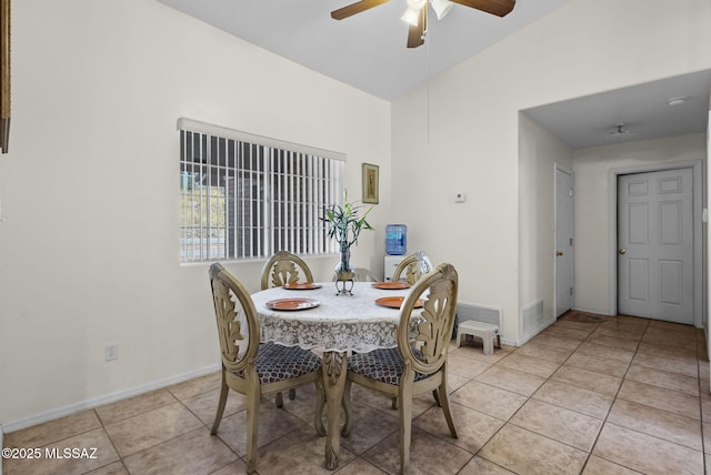 dining area with ceiling fan, light tile patterned floors, and lofted ceiling