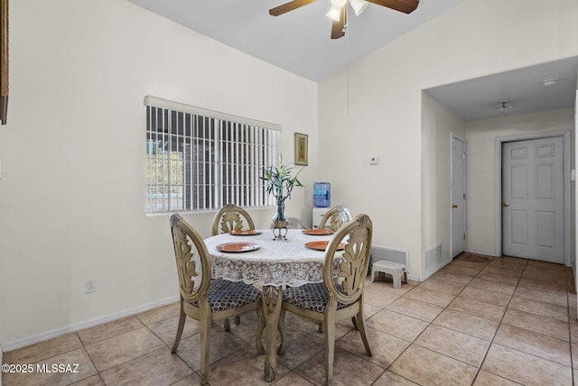 dining area featuring lofted ceiling, visible vents, ceiling fan, light tile patterned floors, and baseboards