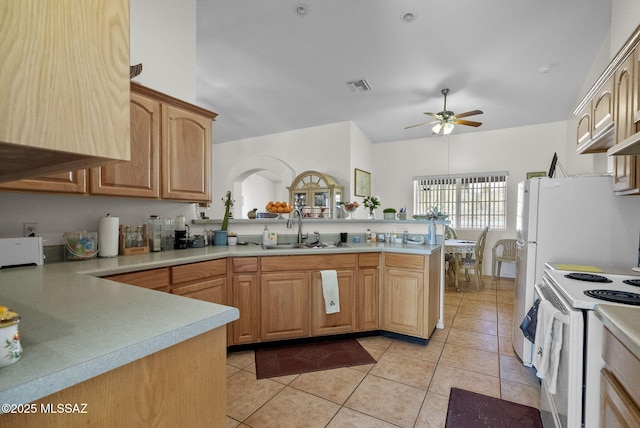 kitchen with light tile patterned floors, kitchen peninsula, ceiling fan, white range with electric cooktop, and sink