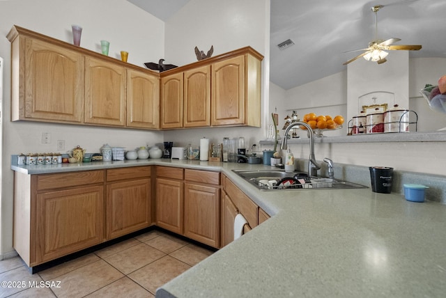 kitchen featuring ceiling fan, sink, light tile patterned floors, and vaulted ceiling