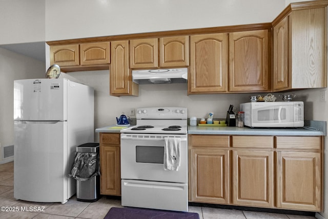 kitchen with white appliances, light countertops, light tile patterned flooring, and under cabinet range hood