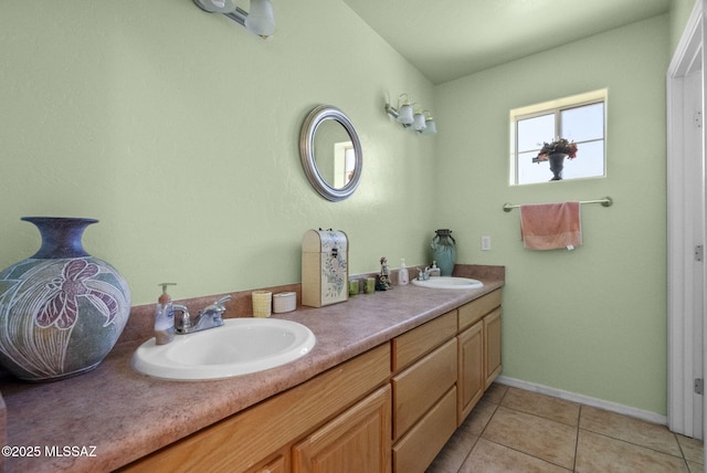 full bathroom with a sink, double vanity, baseboards, and tile patterned floors