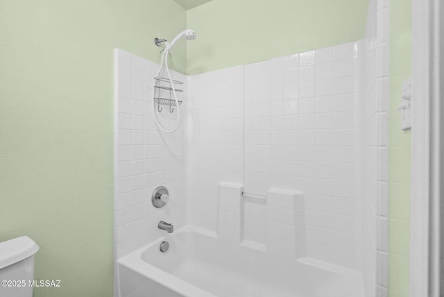 bathroom featuring bathing tub / shower combination and toilet