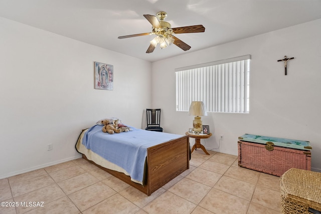 bedroom with ceiling fan, light tile patterned flooring, and baseboards