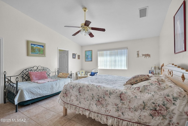 tiled bedroom with ceiling fan and lofted ceiling