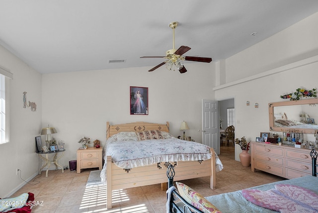 bedroom featuring ceiling fan, visible vents, light tile patterned flooring, and high vaulted ceiling