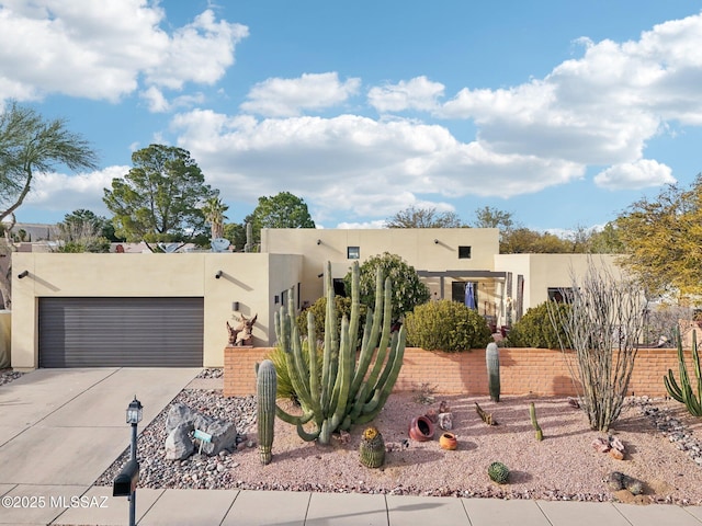 pueblo revival-style home with a garage