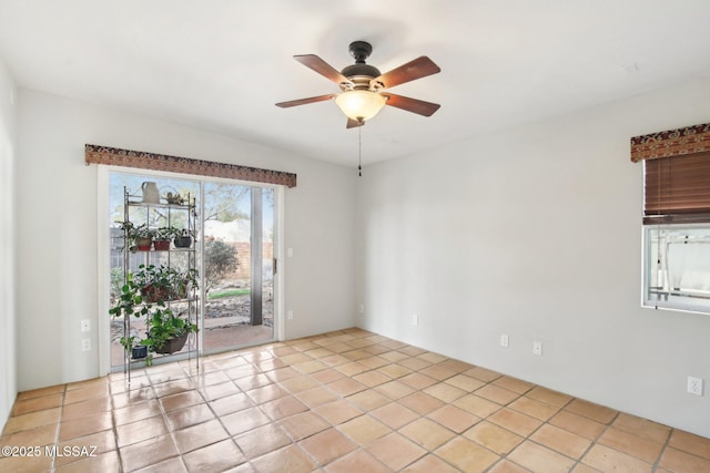 empty room featuring ceiling fan and light tile patterned flooring