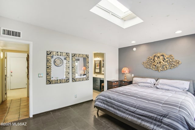 tiled bedroom featuring connected bathroom and a skylight