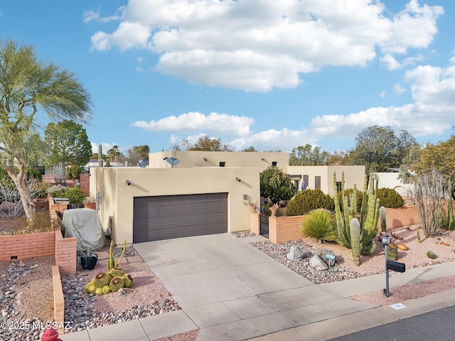 pueblo revival-style home featuring a garage