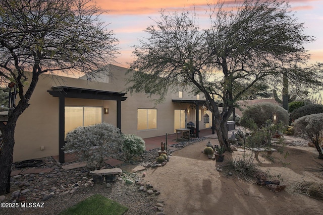 back house at dusk with a patio