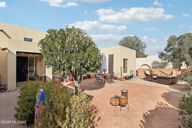 rear view of property with a patio and an outdoor hangout area