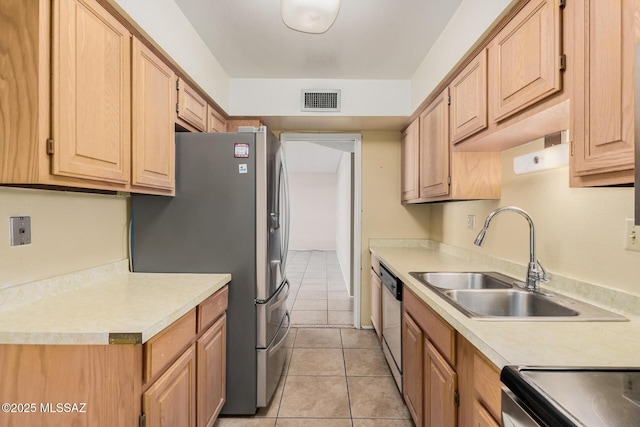 kitchen with stainless steel appliances, light tile patterned floors, light brown cabinets, and sink