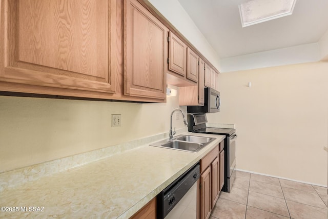 kitchen with sink, light tile patterned floors, and appliances with stainless steel finishes