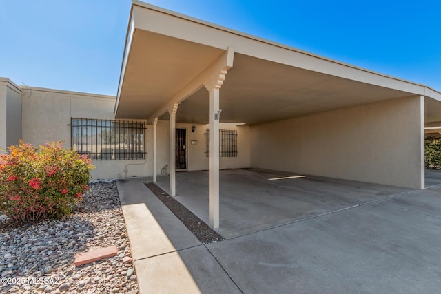 view of vehicle parking with a carport