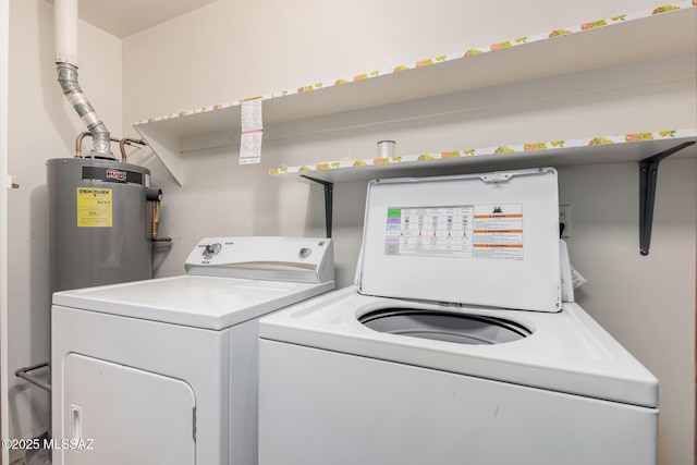 clothes washing area with washing machine and dryer and water heater