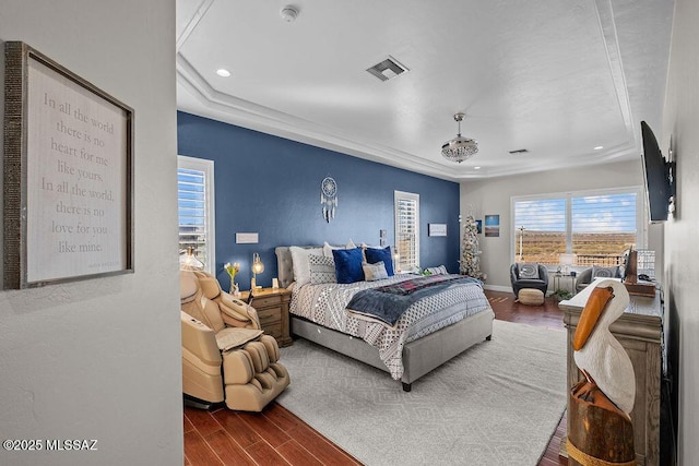 bedroom featuring baseboards, visible vents, wood finished floors, and recessed lighting