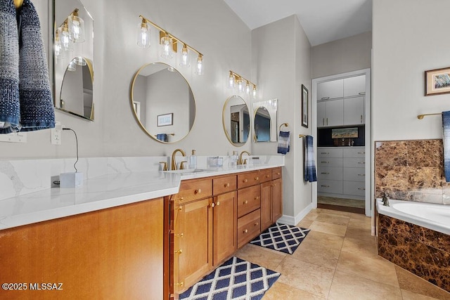 full bath featuring double vanity, tiled bath, a sink, and tile patterned floors