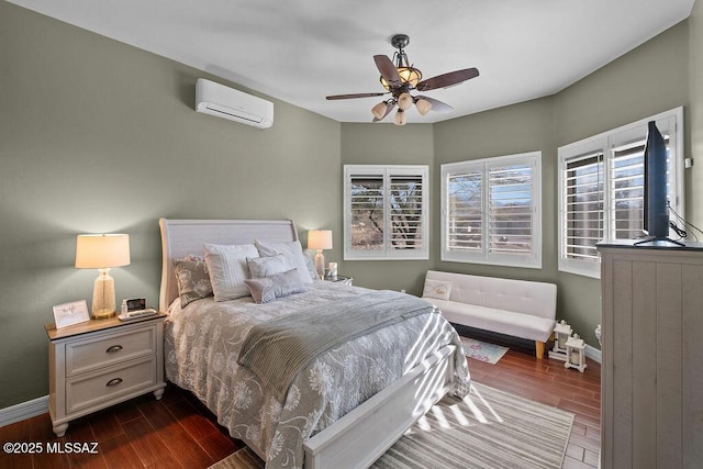 bedroom featuring an AC wall unit, baseboards, ceiling fan, and dark wood-style flooring