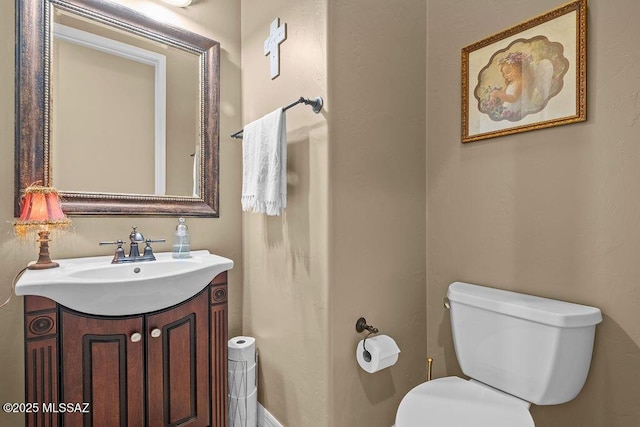 bathroom featuring toilet and vanity