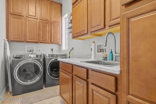 washroom featuring independent washer and dryer, cabinet space, a sink, and light tile patterned floors