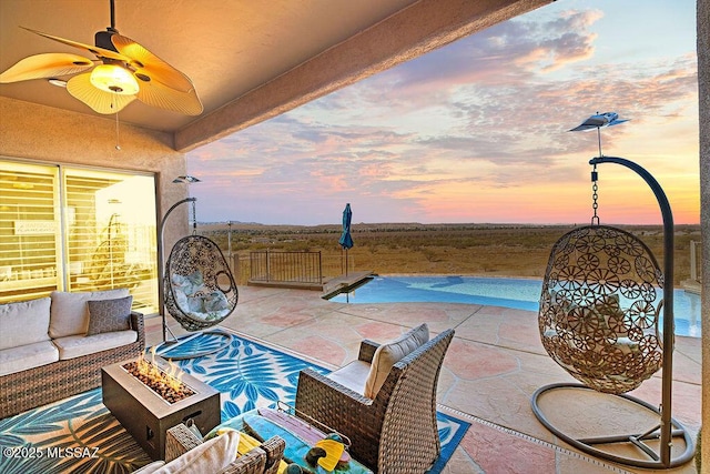 view of swimming pool featuring a patio area, an outdoor living space with a fire pit, and ceiling fan