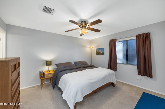 bedroom with ceiling fan and light carpet