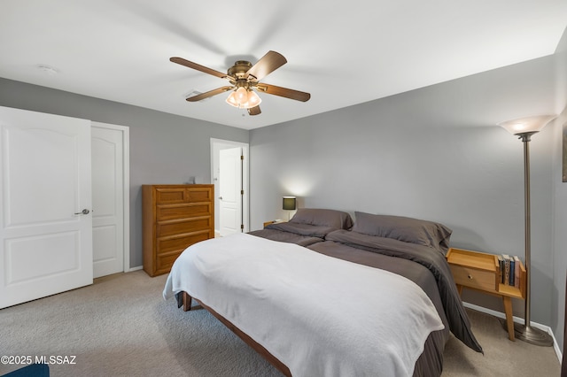 bedroom featuring ceiling fan and light carpet