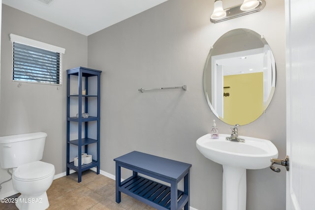 bathroom with toilet and tile patterned floors